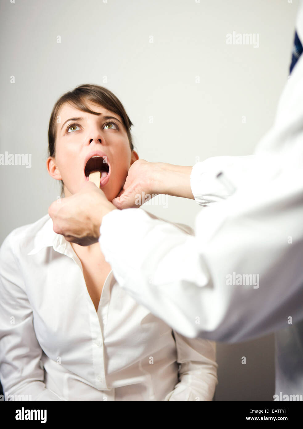 doctor and patient with tongue depressor Stock Photo Alamy