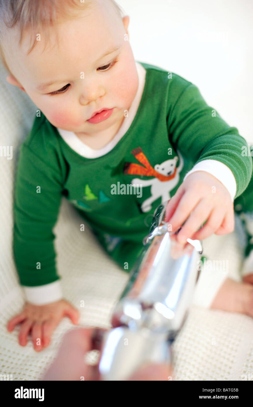 Baby boy playing with a Christmas cracker. He is nine months old. Stock Photo