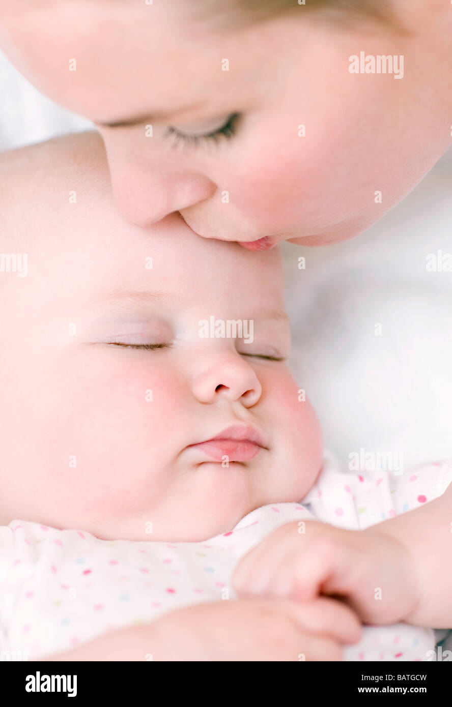 Mother and baby. Mother kissingher sleeping 7 month old baby girl on