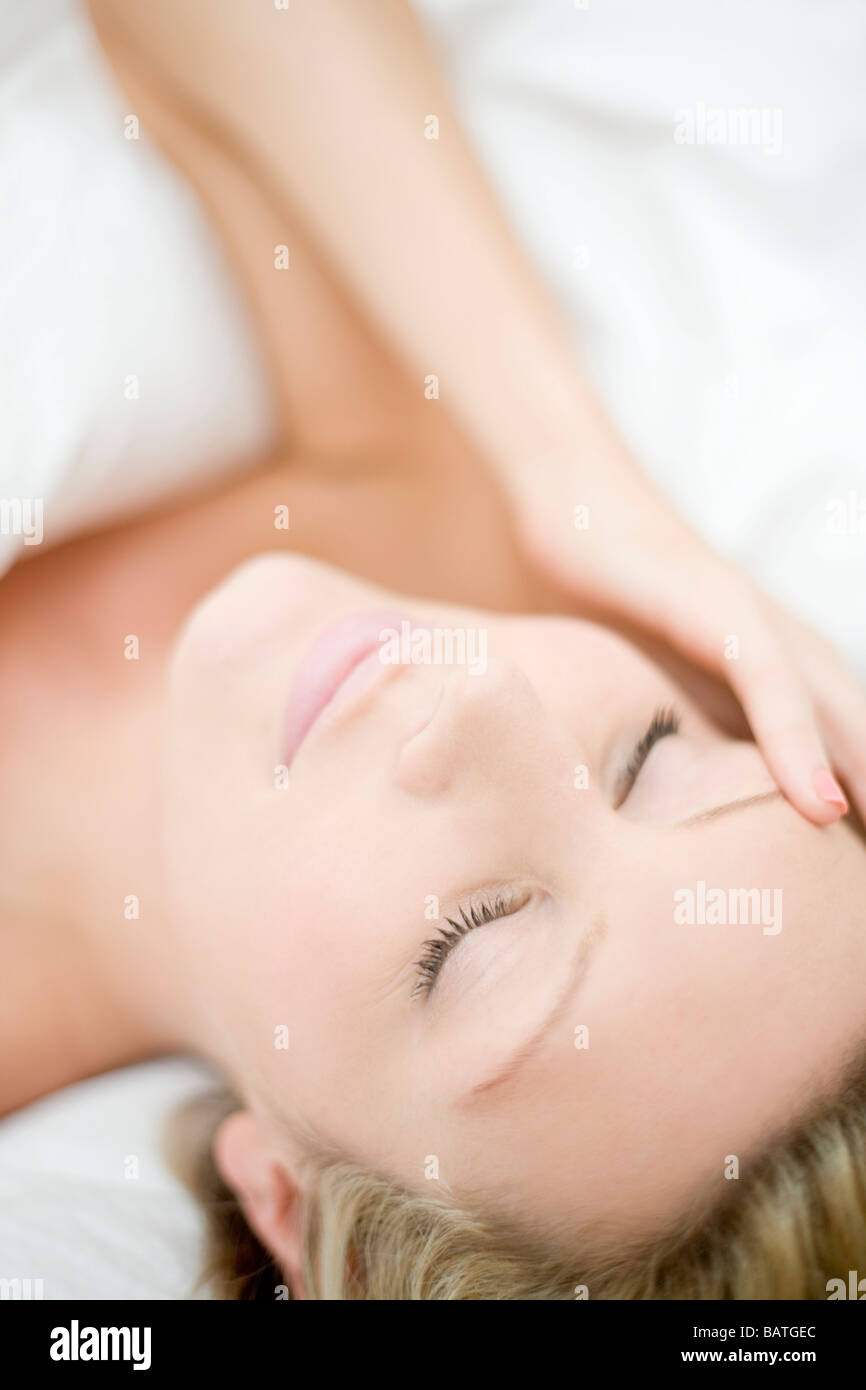 Young woman with a headache lying down Stock Photo Alamy