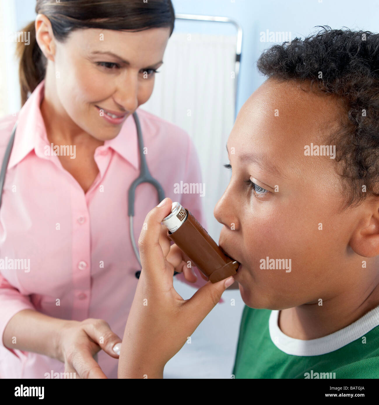 Using asthma inhaler.Doctor instructing a boy on how to use an asthma