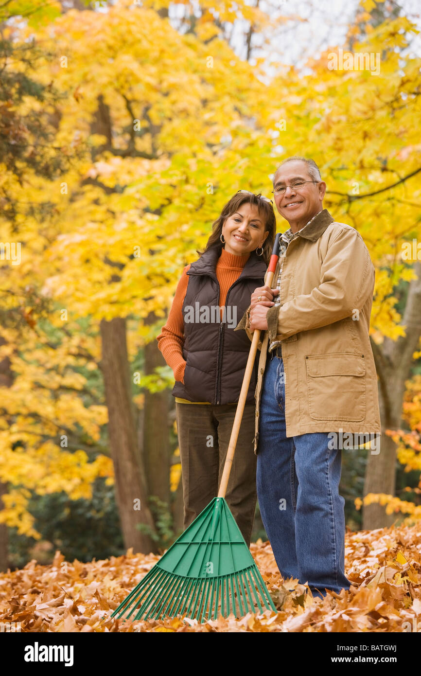 Hispanic couple raking autumn leaves Stock Photo - Alamy