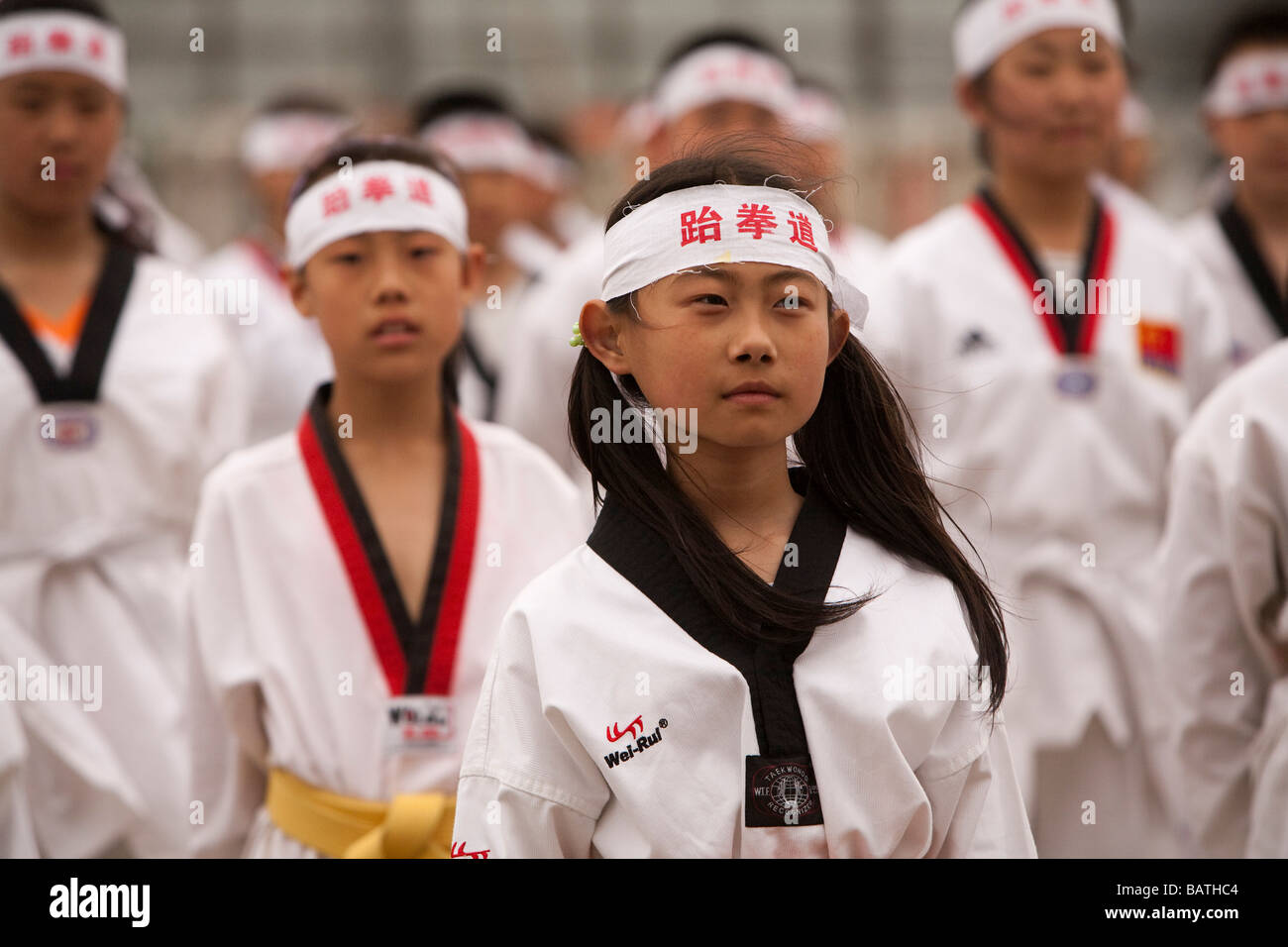 School children  at the city sports stadium  to rehearse for a parade in front of Party Leaders, Changchun,  Jilin Province, China Stock Photo