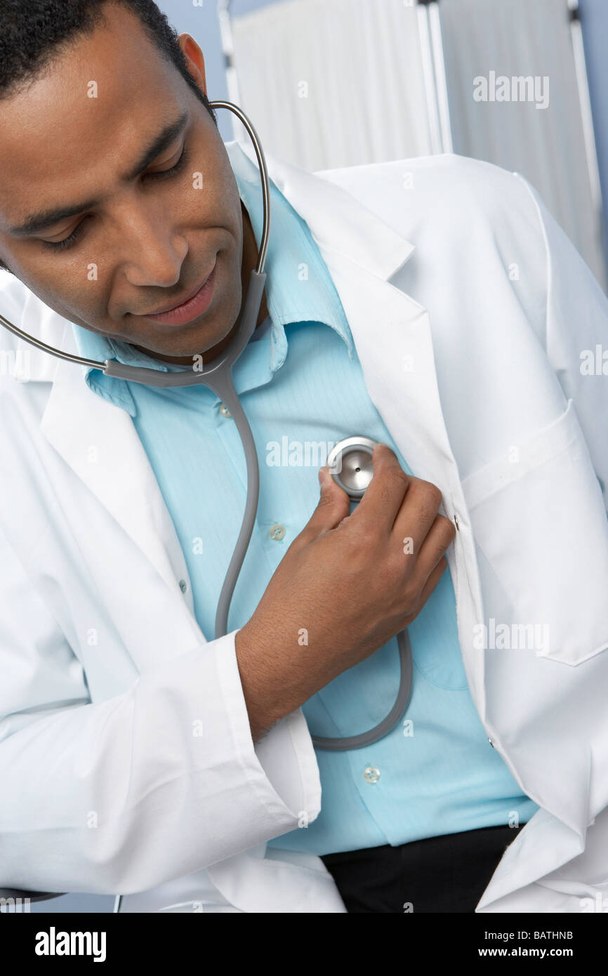 Doctor listening to his heartusing a stethoscope, a medical device that is  usedto listen to sounds within the body Stock Photo - Alamy