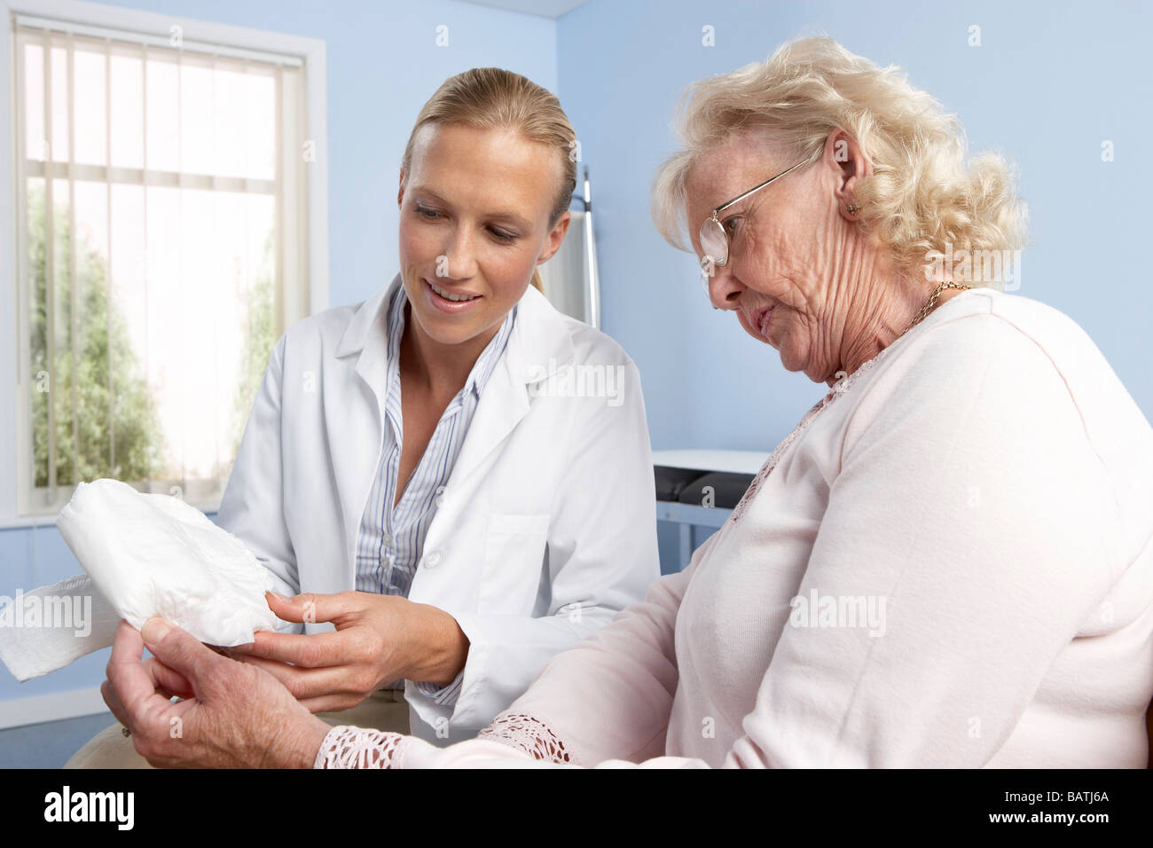 Incontinence. General practitioner explains the use of a urinary