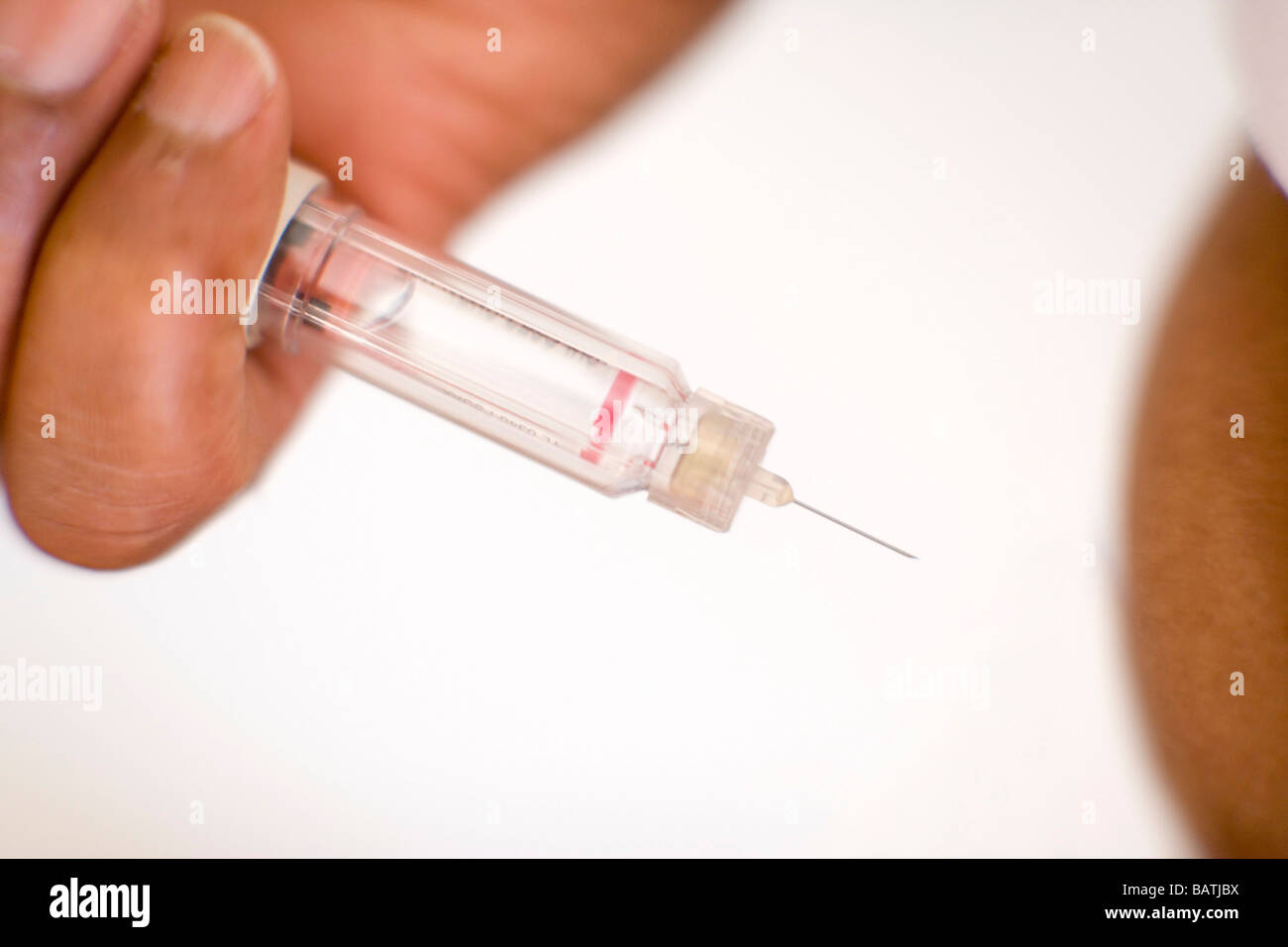 Insulin injection. Diabetic man injecting himself with insulin. He is
