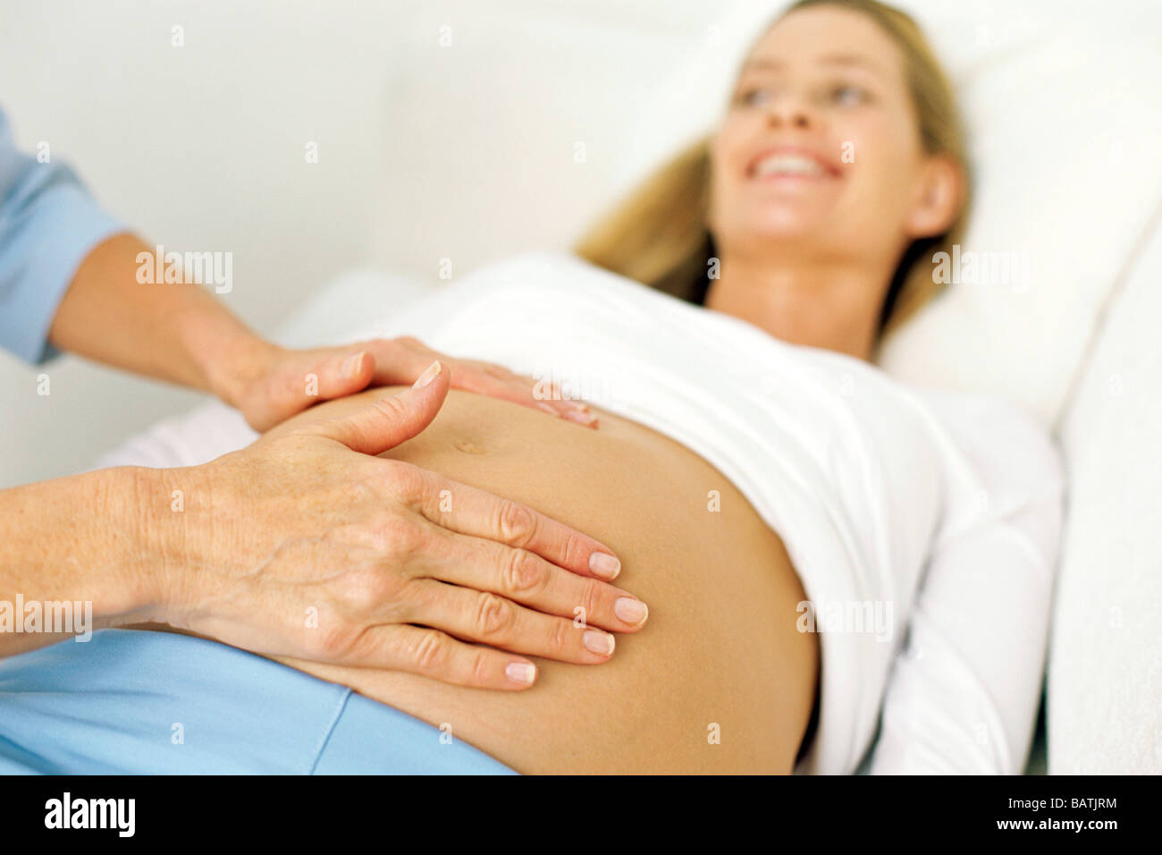 pregnancy for exam examination. Obstetric woman a Midwife pregnant measuring