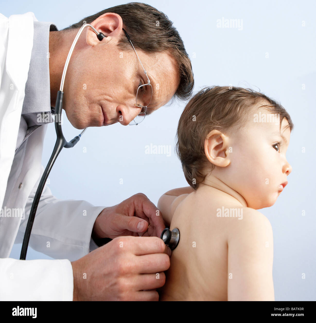 Paediatric examination. Doctor using a stethoscope to listen the heart