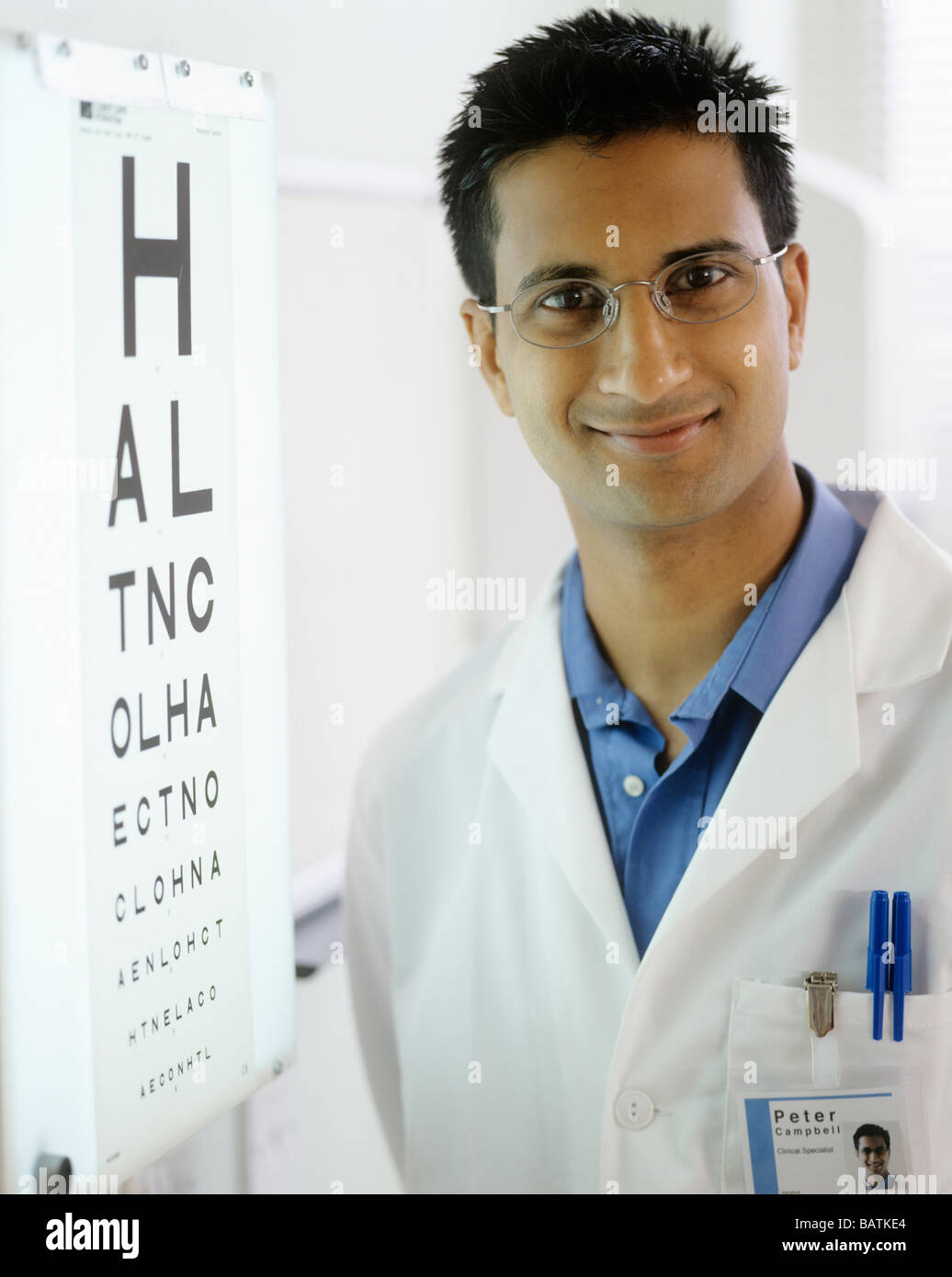 Optometrist next to an eyechart. The eye chart is used to test a person