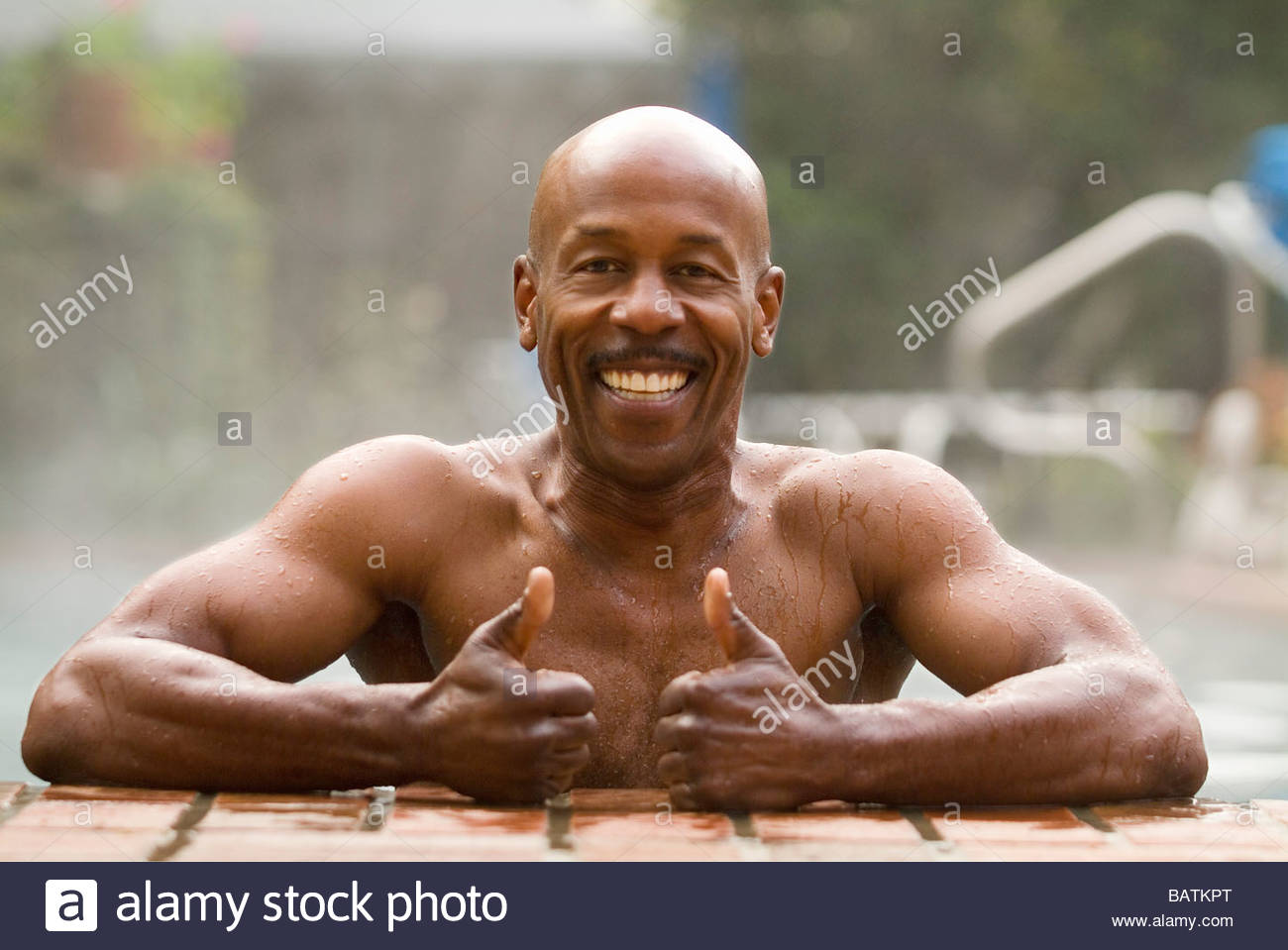 African Man In Pool Giving Thumbs Up Gesture African Man In Pool Giving Thumbs Up Gesture