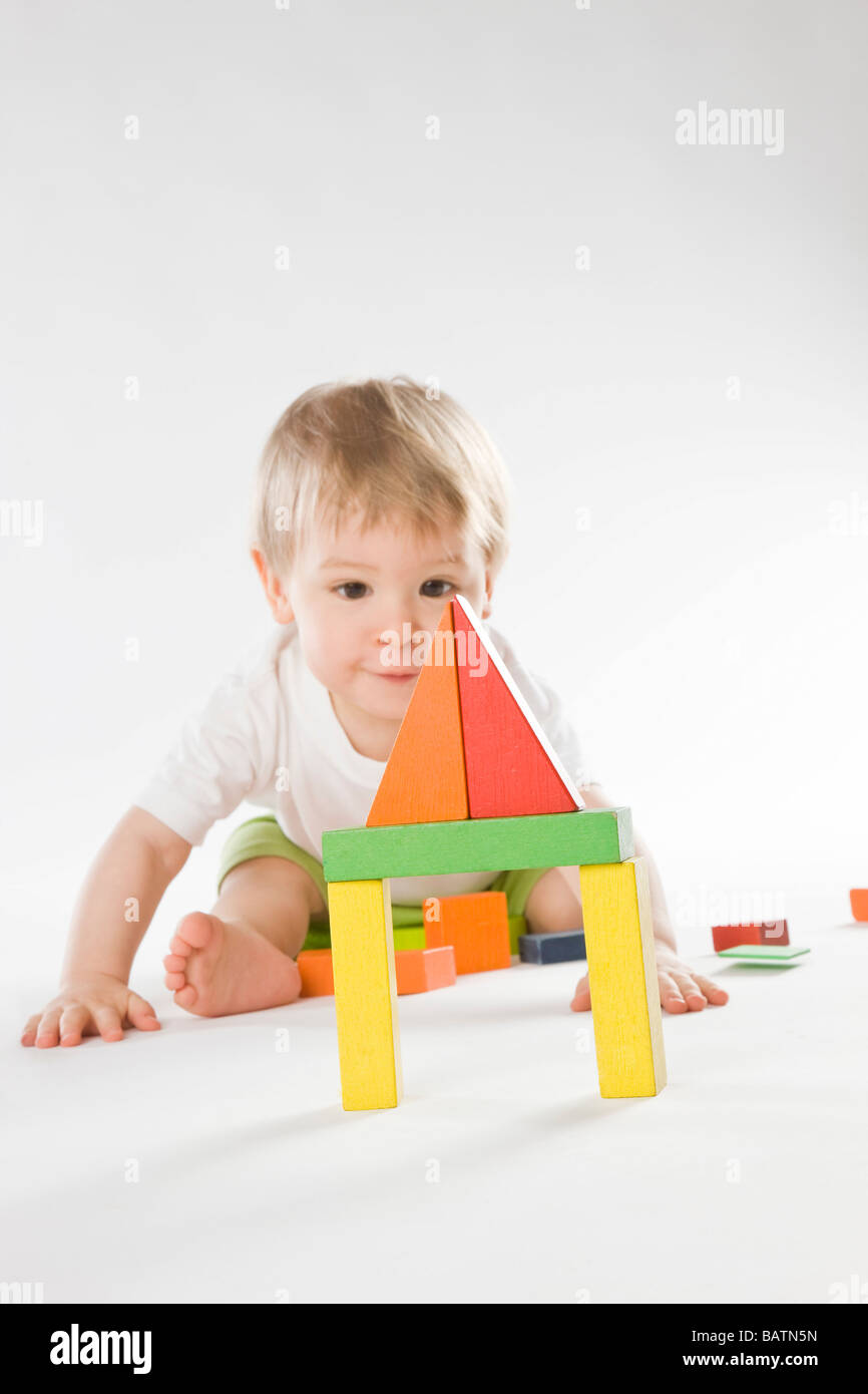baby boy looking at colorful blocks Stock Photo