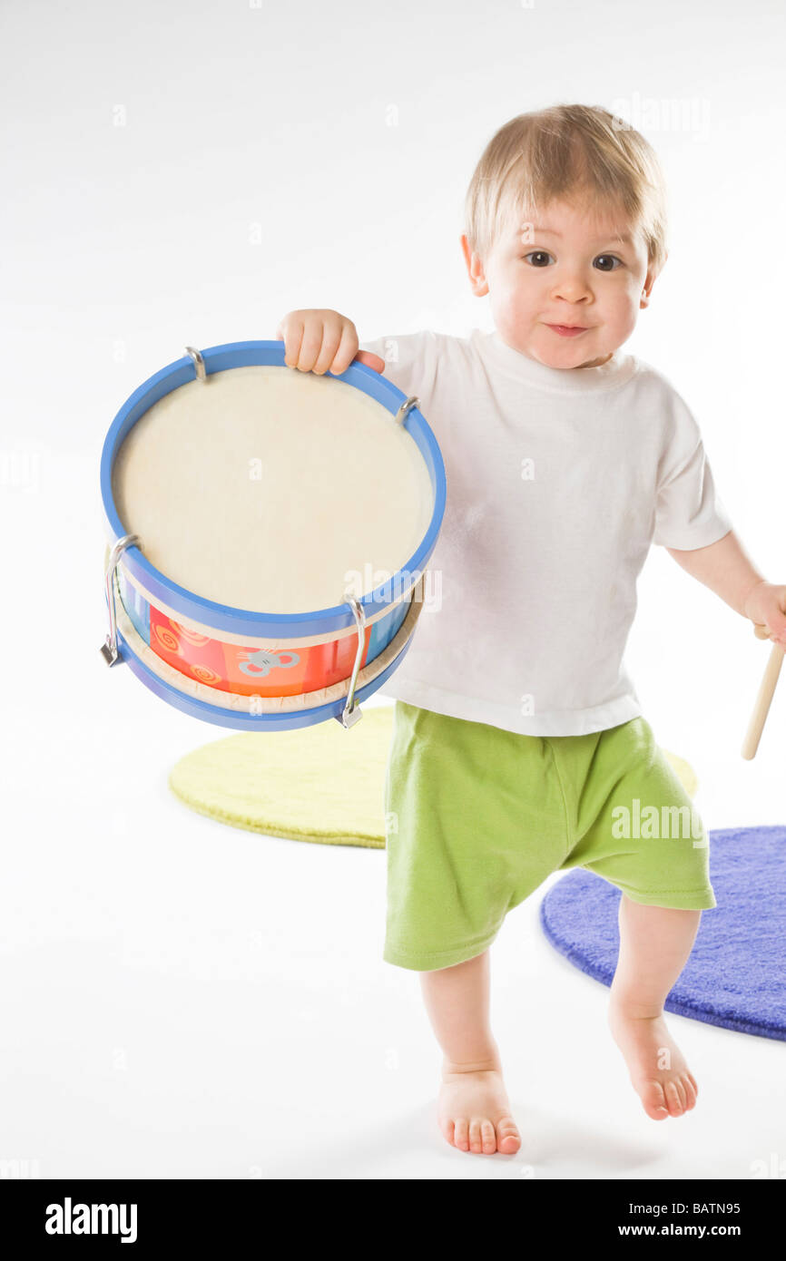 baby boy carrying drum Stock Photo Alamy