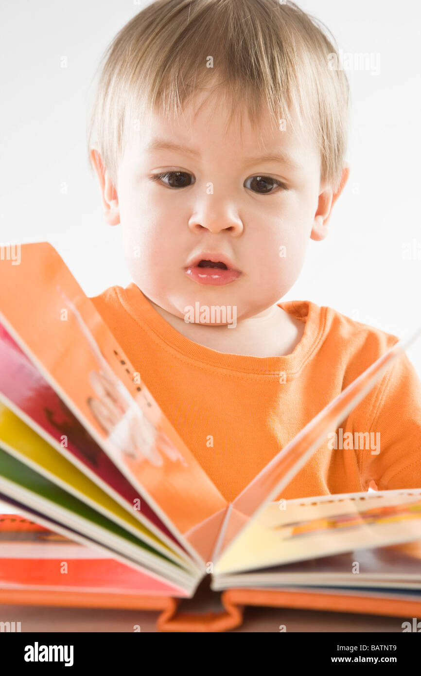 baby boy reading book Stock Photo Alamy