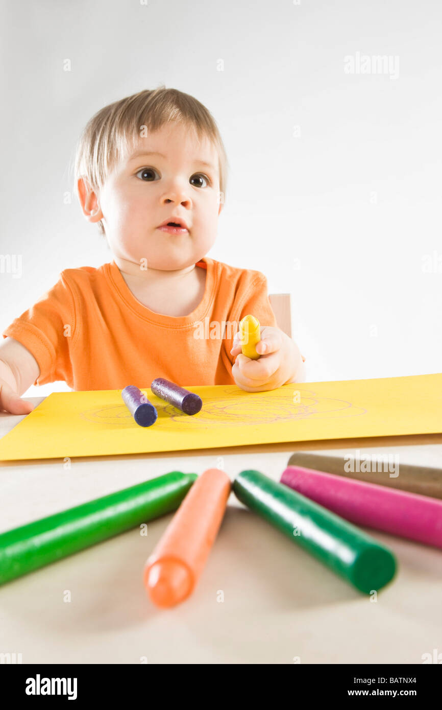 small boy drawing with colorful crayons Stock Photo