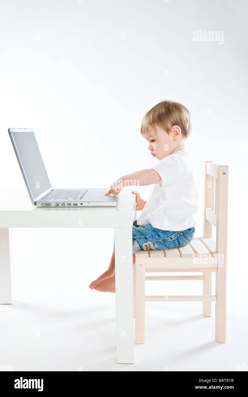 baby boy typing on laptop Stock Photo