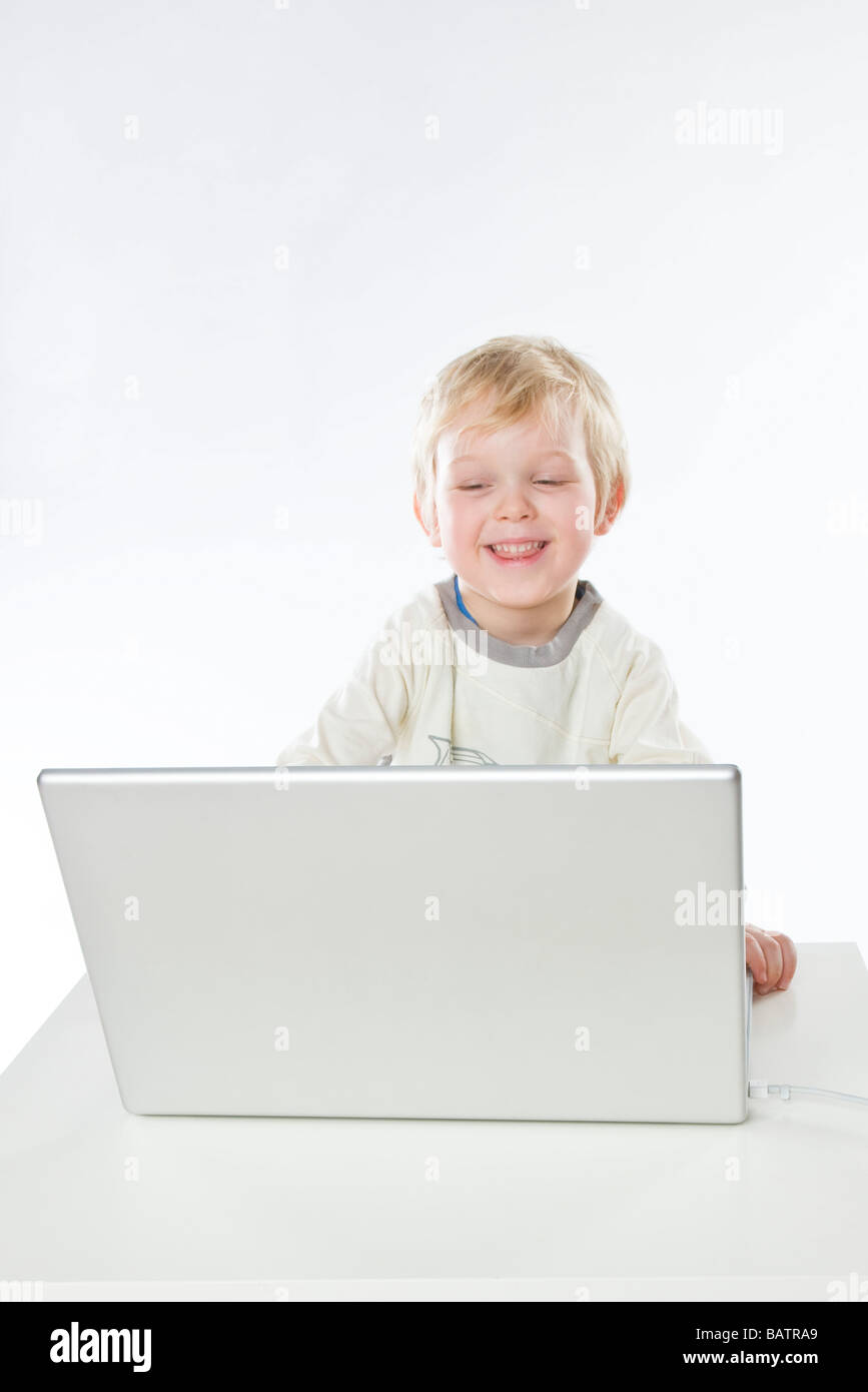 toddler boy playing on laptop Stock Photo