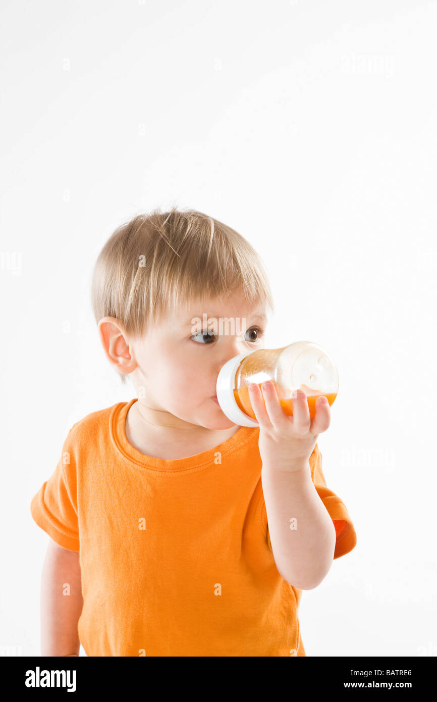 Download Baby Boy Drinking Carrot Juice From Bottle Stock Photo Alamy PSD Mockup Templates