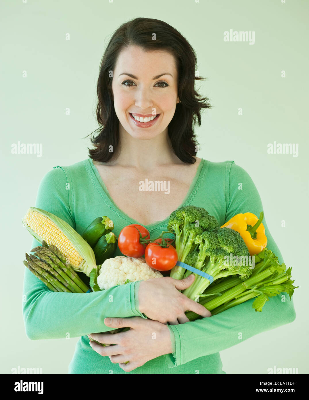 Woman holding various vegetables Stock Photo