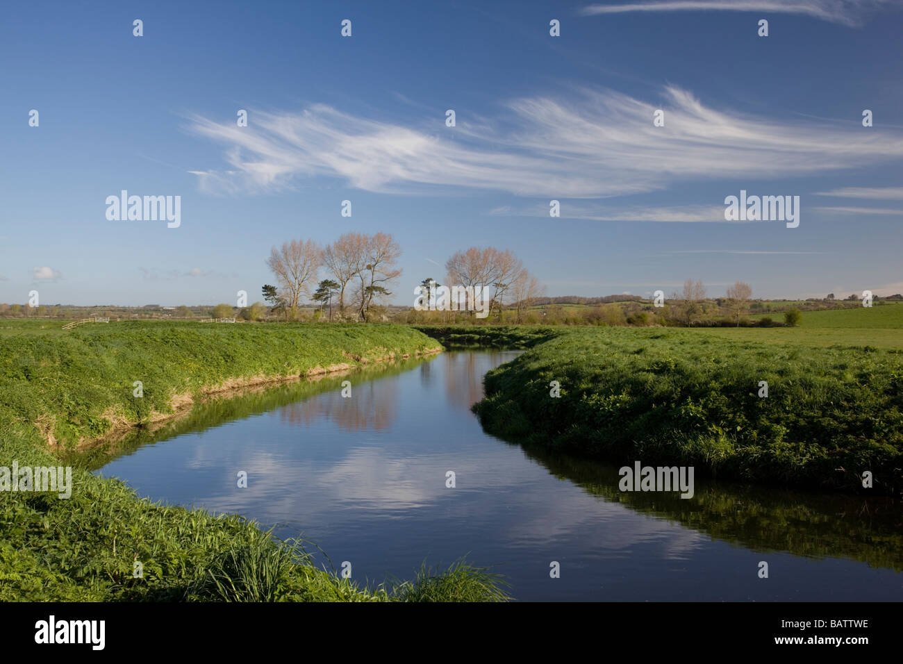 Spring clouds reflected in the River Yeo on the Somerset Levels near Langport Stock Photo