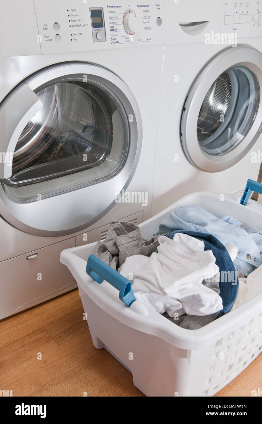 Laundry in basket in launderette Stock Photo Alamy