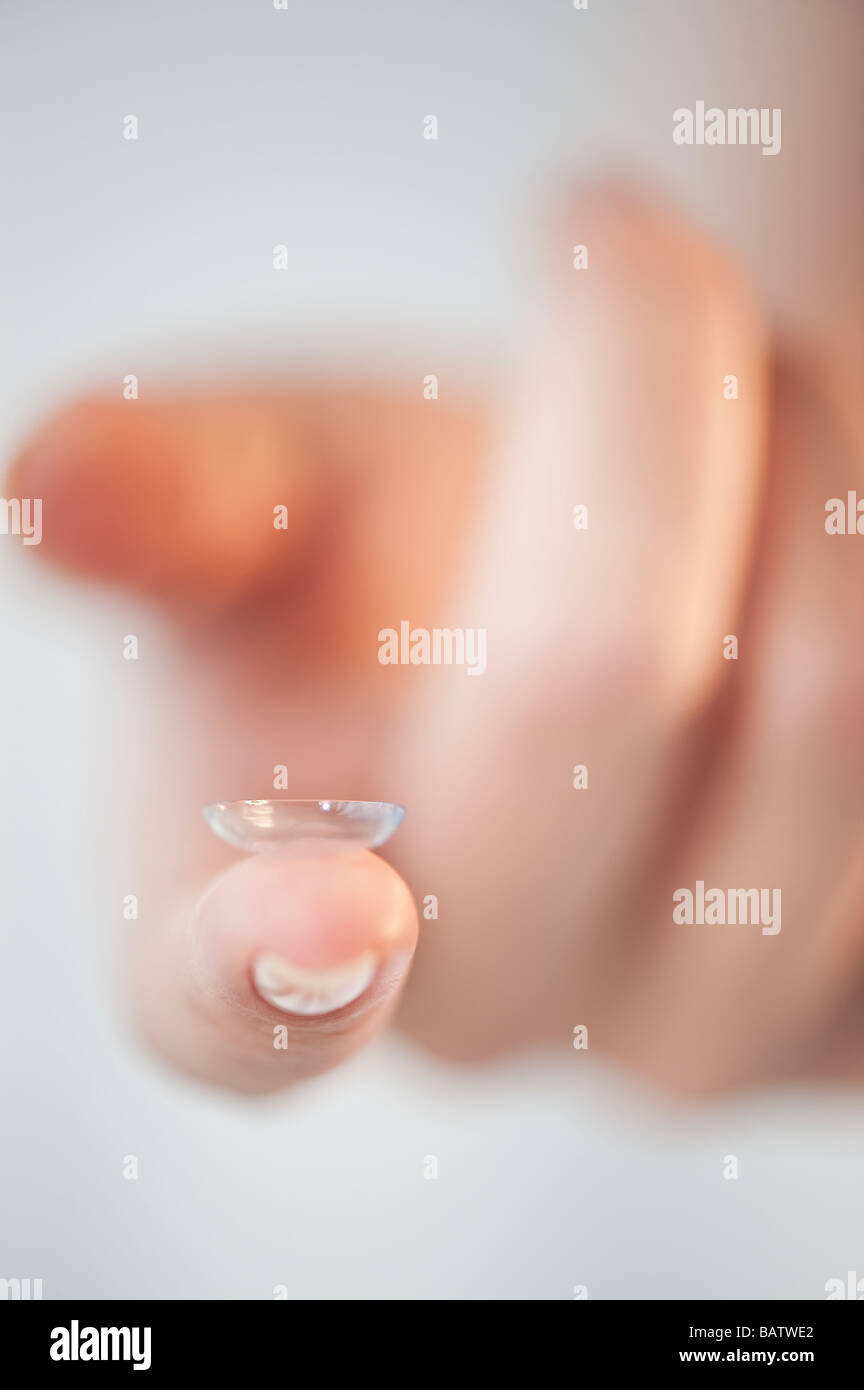 Close-up of contact lens on woman's finger Stock Photo