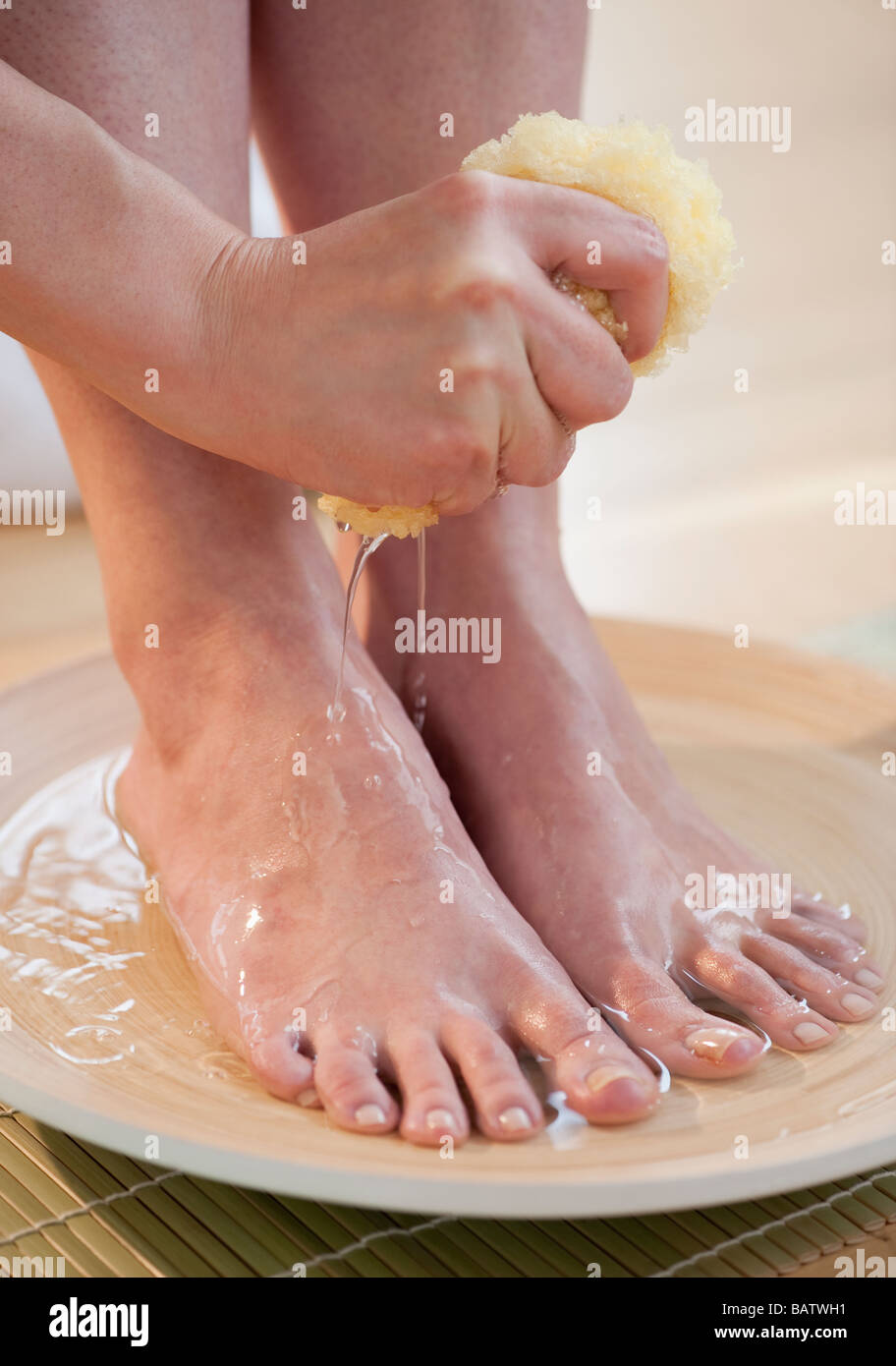 Close-up of woman washing feet Stock Photo