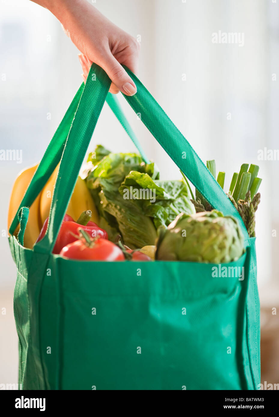 Woman holding grocery bag, close-up Stock Photo