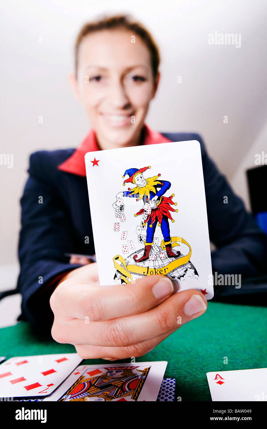 happy young woman holding joker card Stock Photo