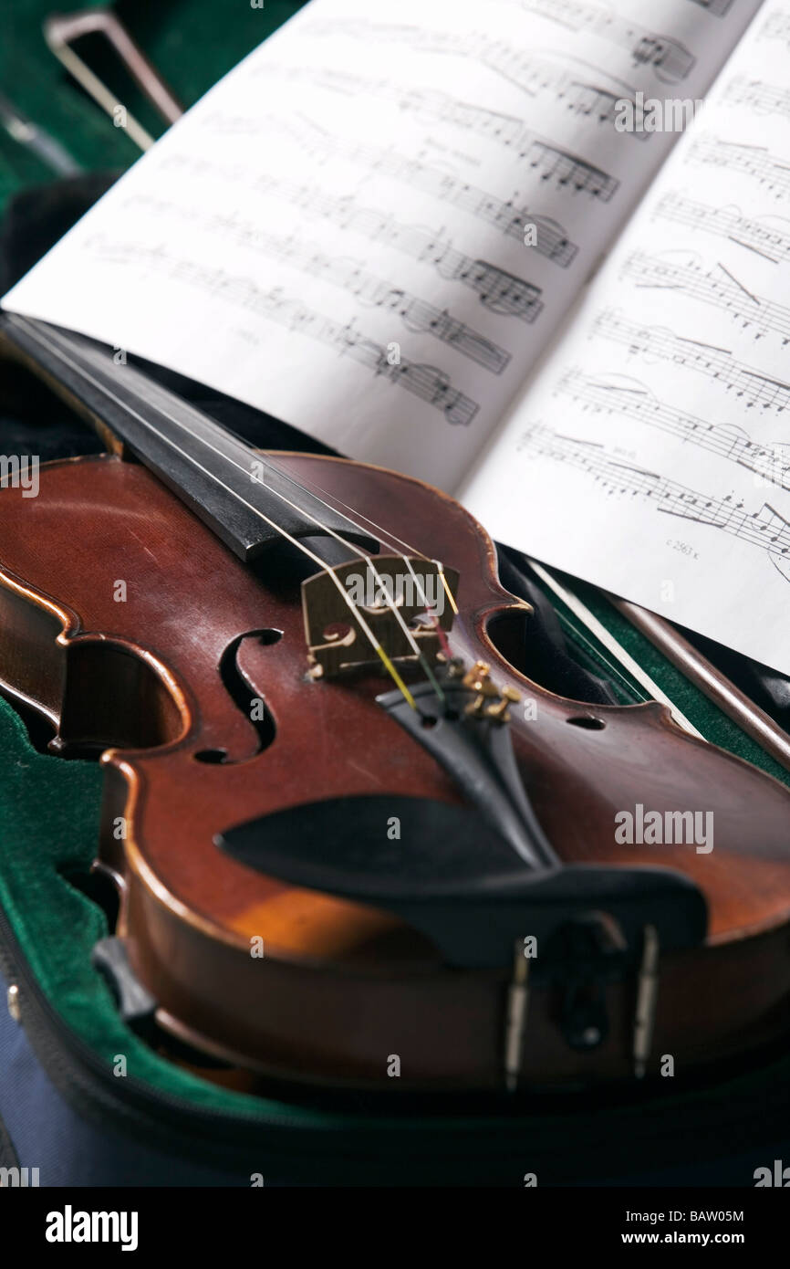 still life of violin in case and sheet of music Stock Photo