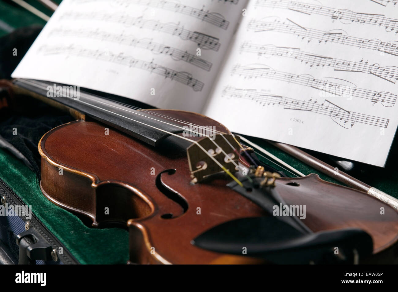 still life of violin in case and sheet of music Stock Photo