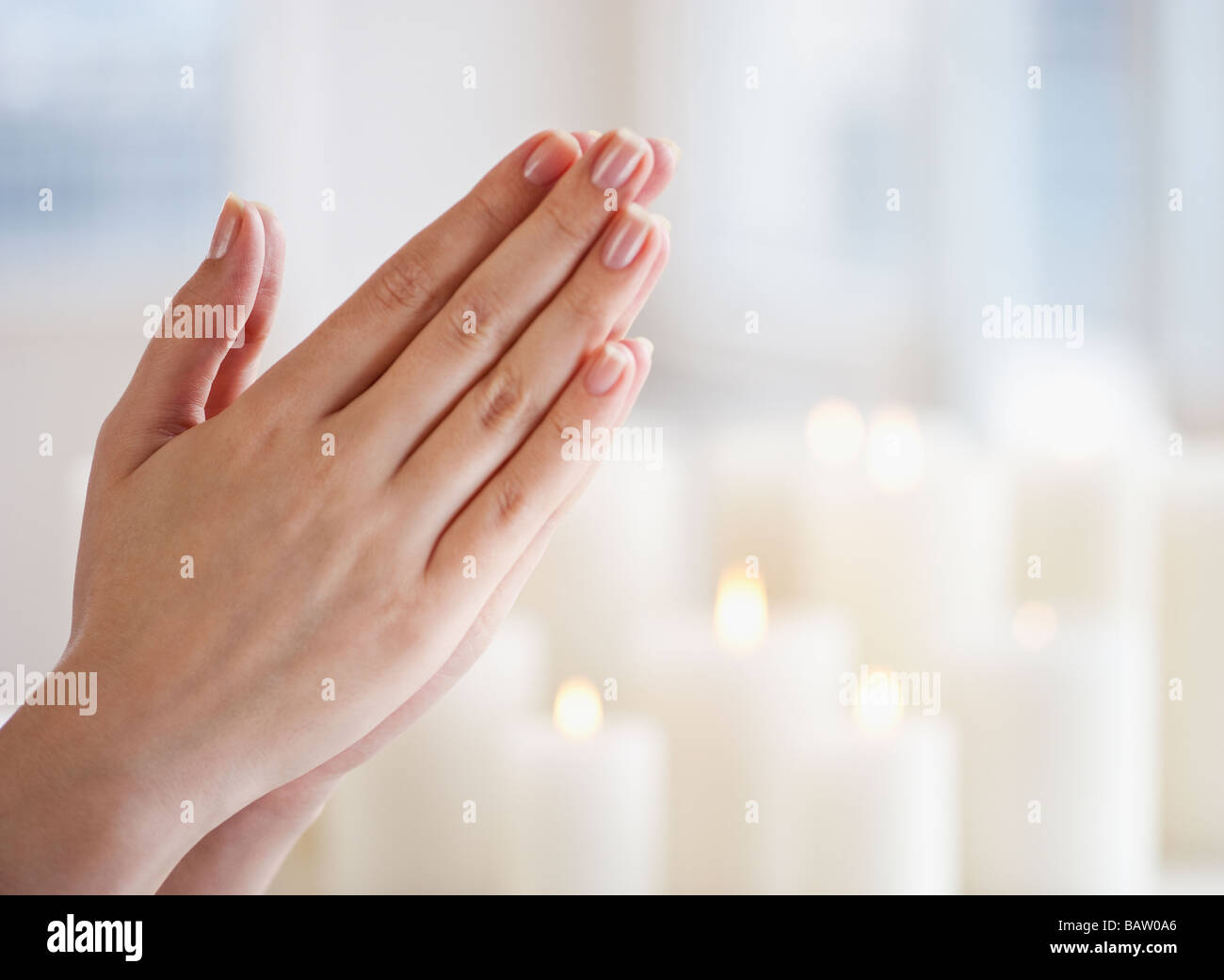 Woman praying, close-up of hands Stock Photo