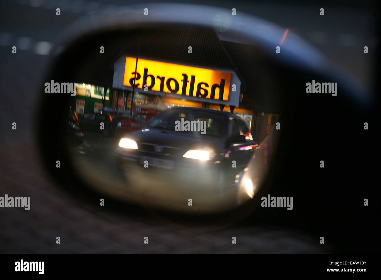 A Halfords store reflected in a car mirror Stock Photo Alamy