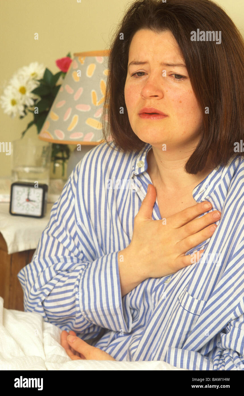 woman with her hand on her chest suffering with night panics or
