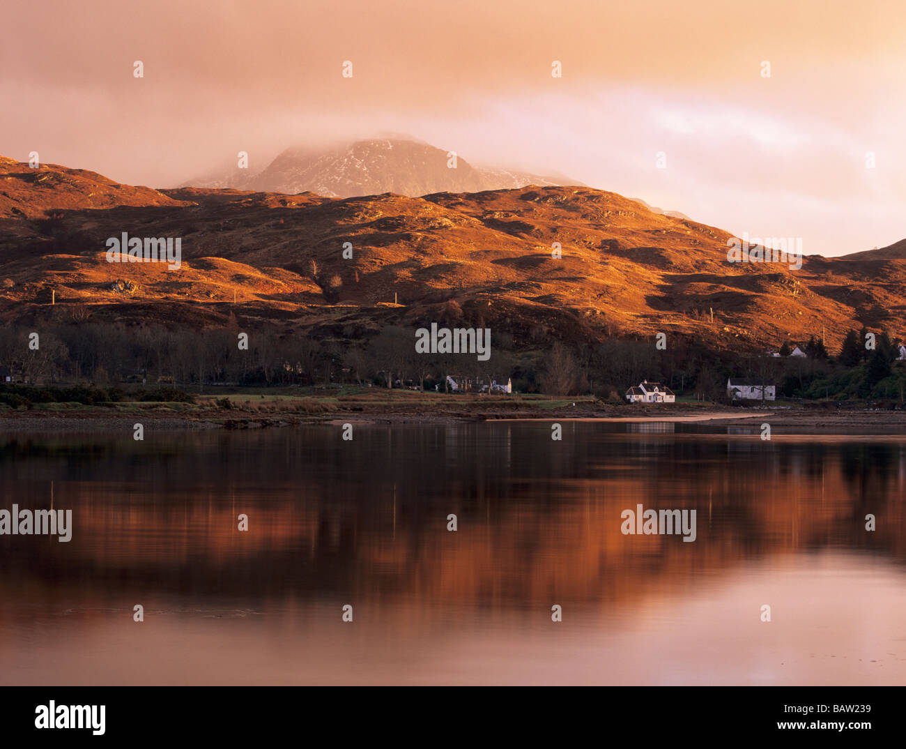 DUSK over GLENELG VILLAGE with last rays of sun on hills reflected in Glenmore River estuary in Highland Scotland UK Britain Stock Photo