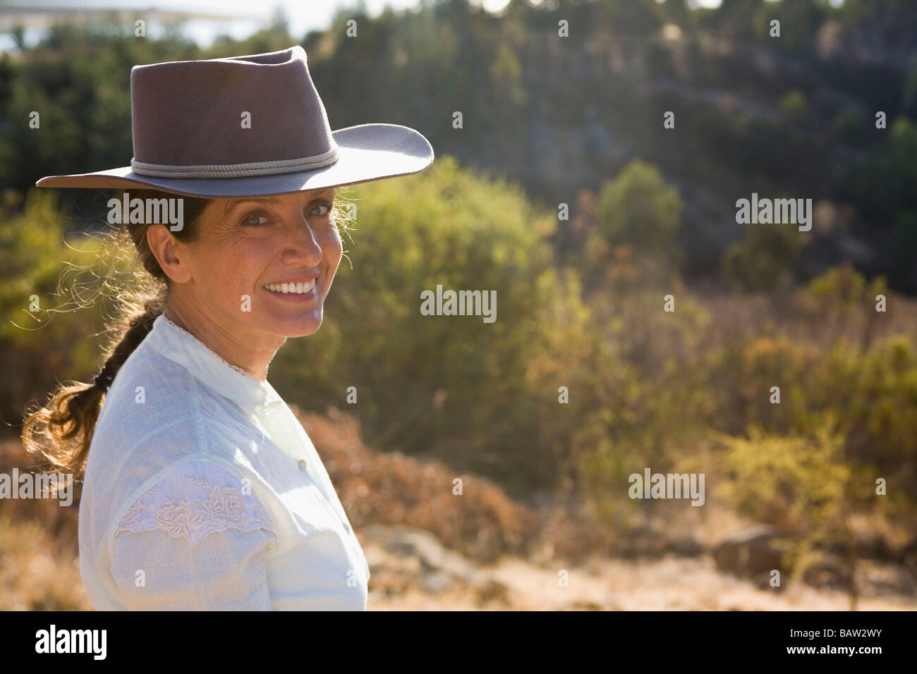 Hispanic woman wearing hat in remote location Stock Photo