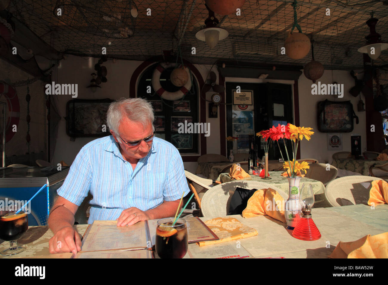 Man reading menu in restaurant in Puerto de Mogan Gran Canaria Spain Europe Stock Photo