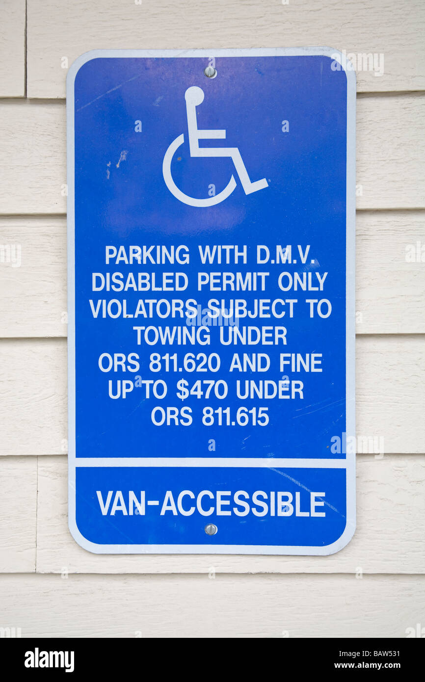 A parking with permit only sign for handicapped and wheelchair bound people Stock Photo