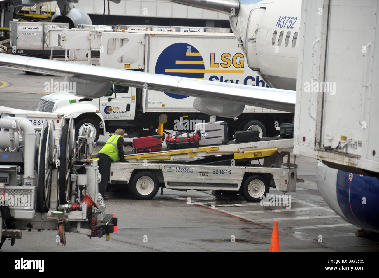 Loading, unloading luggage at airport Stock Photo Alamy