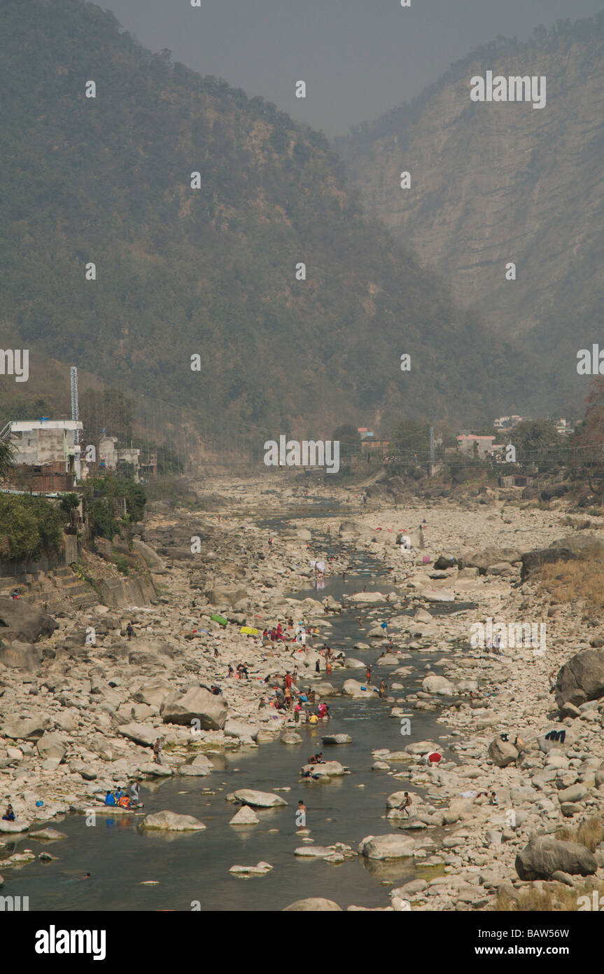 People wash in a river in the mountains Stock Photo