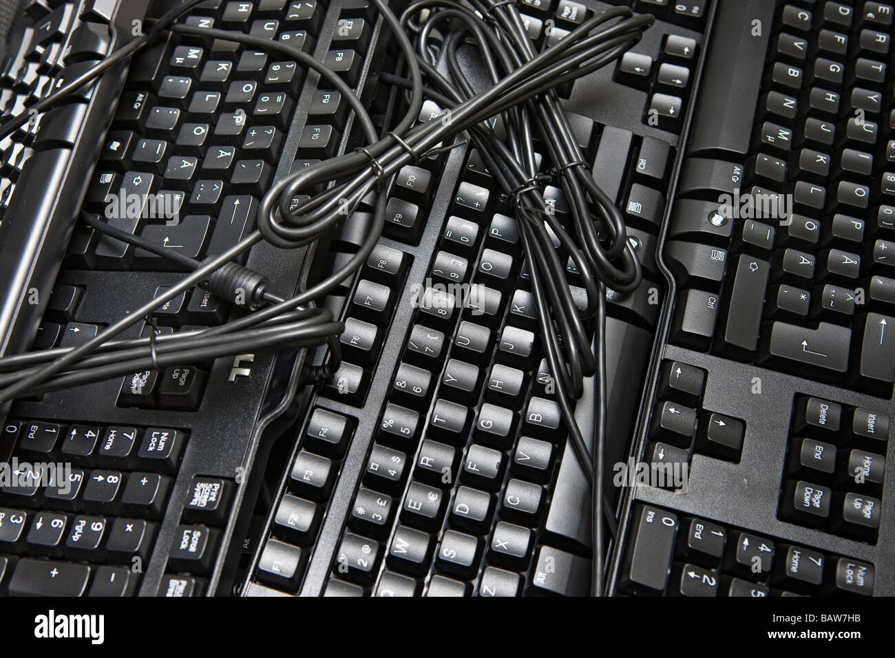Black computer keyboards and cables Stock Photo Alamy