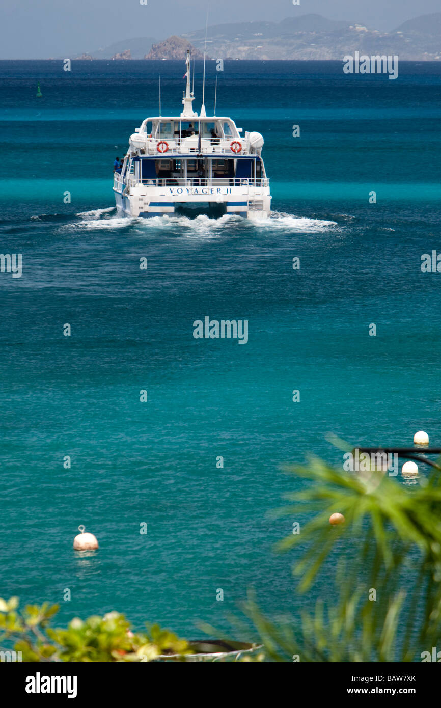Voyager catamaran ferry leaves Gustavia port St Barts for neighboring St Martin Stock Photo
