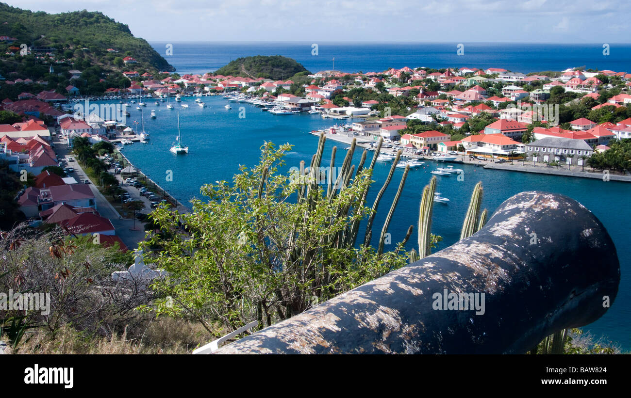 Replica cannon at Fort Gustave above red tin roof buildings in port town of Gustavia St Barts Stock Photo