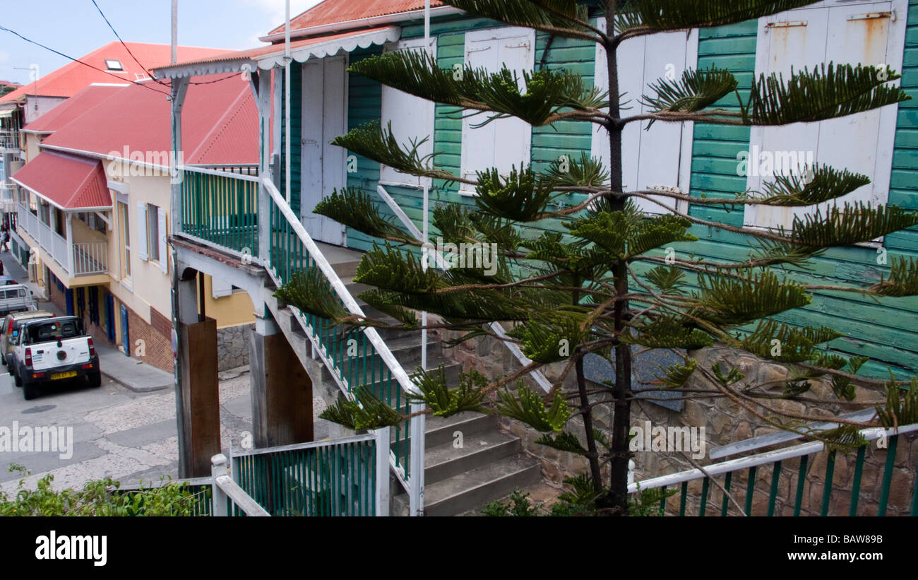 Steps and stairs lead to wooden houses and buildings lining the steep sides of Gustavia port St Barts Stock Photo