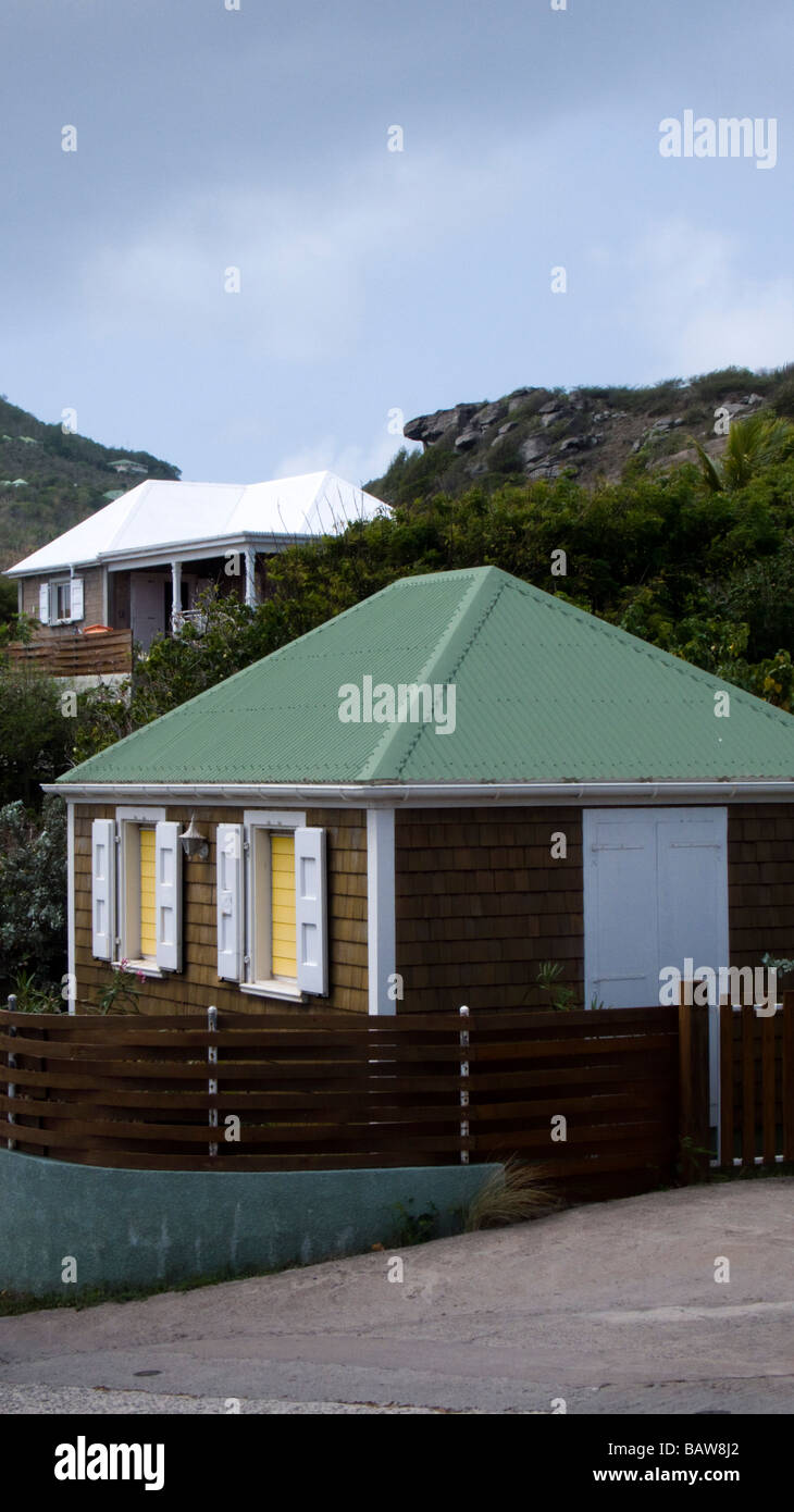 Traditional wood shingle house with tin roof and shutters St Barts Stock Photo