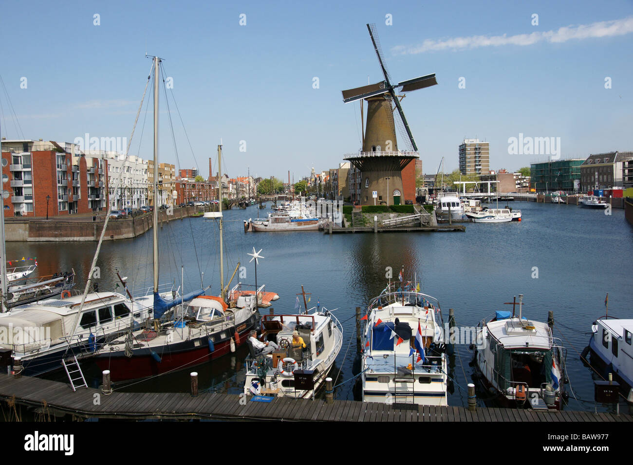 Schiedam part of Rotterdam, harbour and windmill and mooring yachts Stock Photo