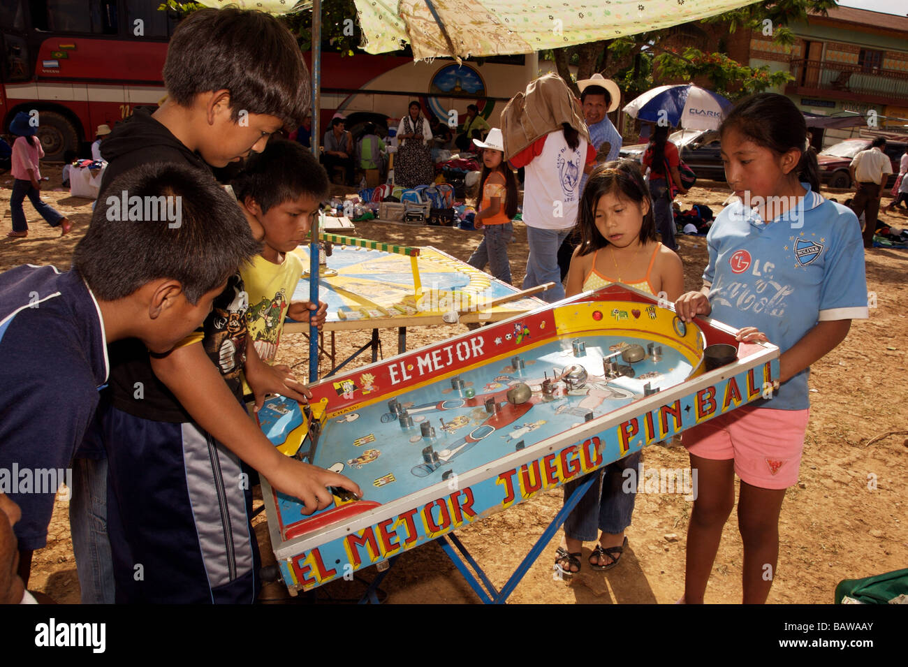 kids play a pin-ball game in the town square at a festival in Apolo Bolivia  Stock Photo - Alamy