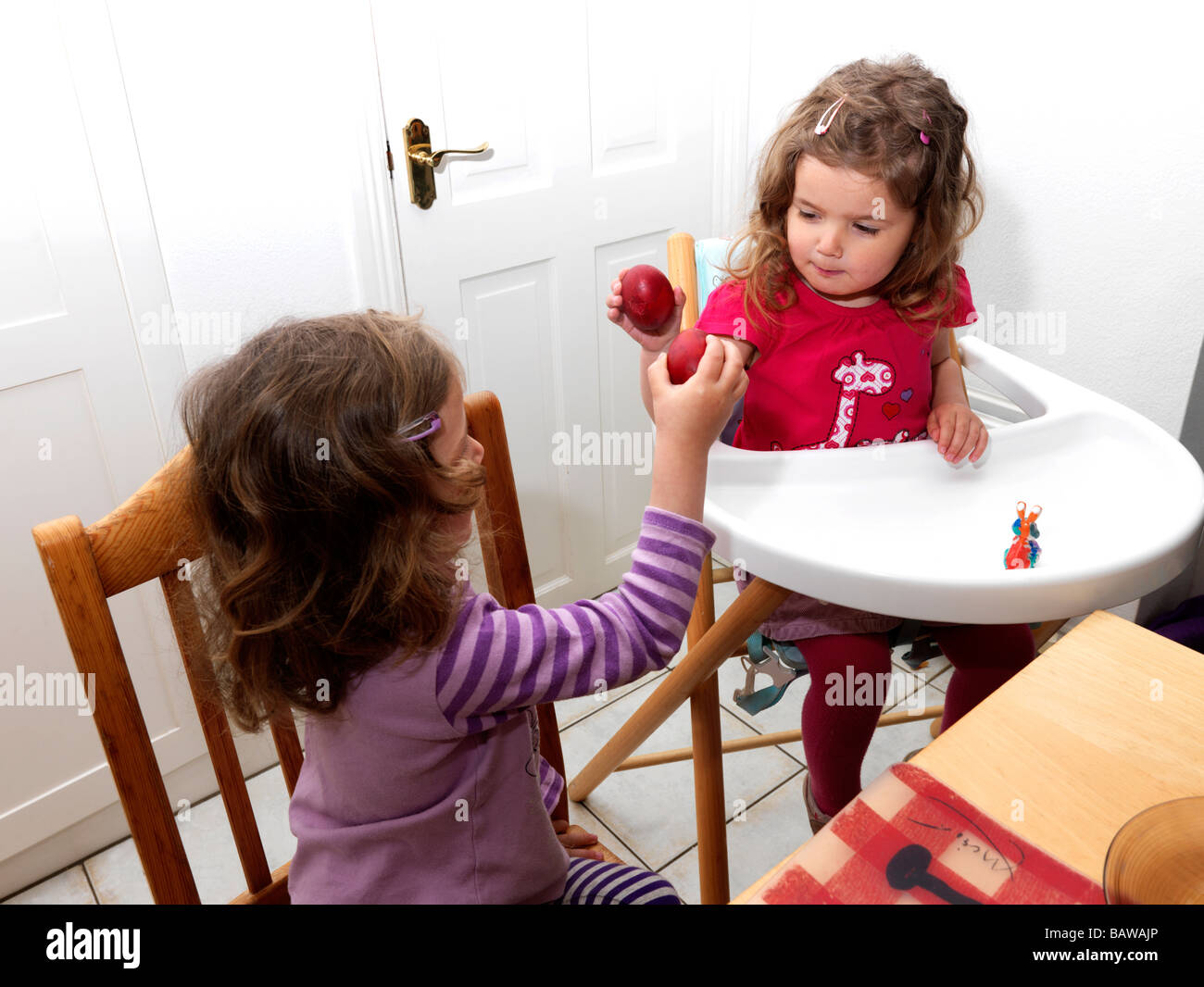 Cracking Red Eggs at Easter Stock Photo Alamy