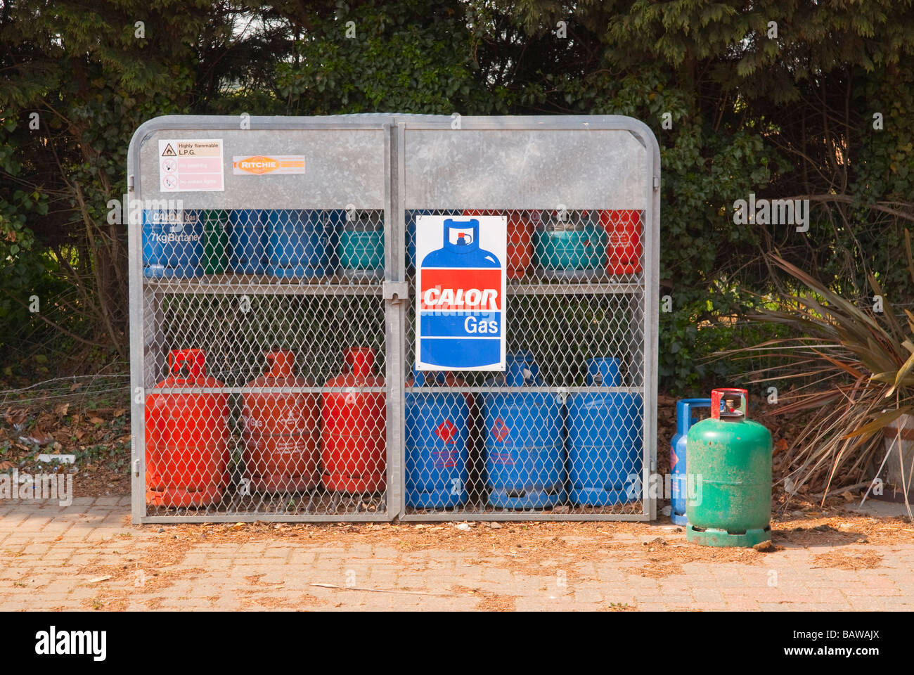 A cage with butane and propane gas bottles in for sale at a uk garden centre selling gases Stock Photo