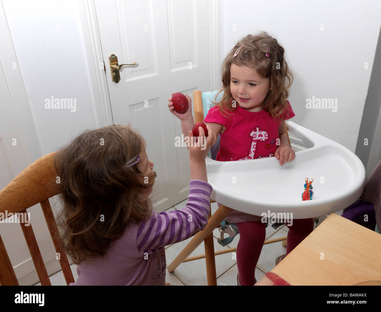 Cracking Red Eggs at Easter Stock Photo Alamy