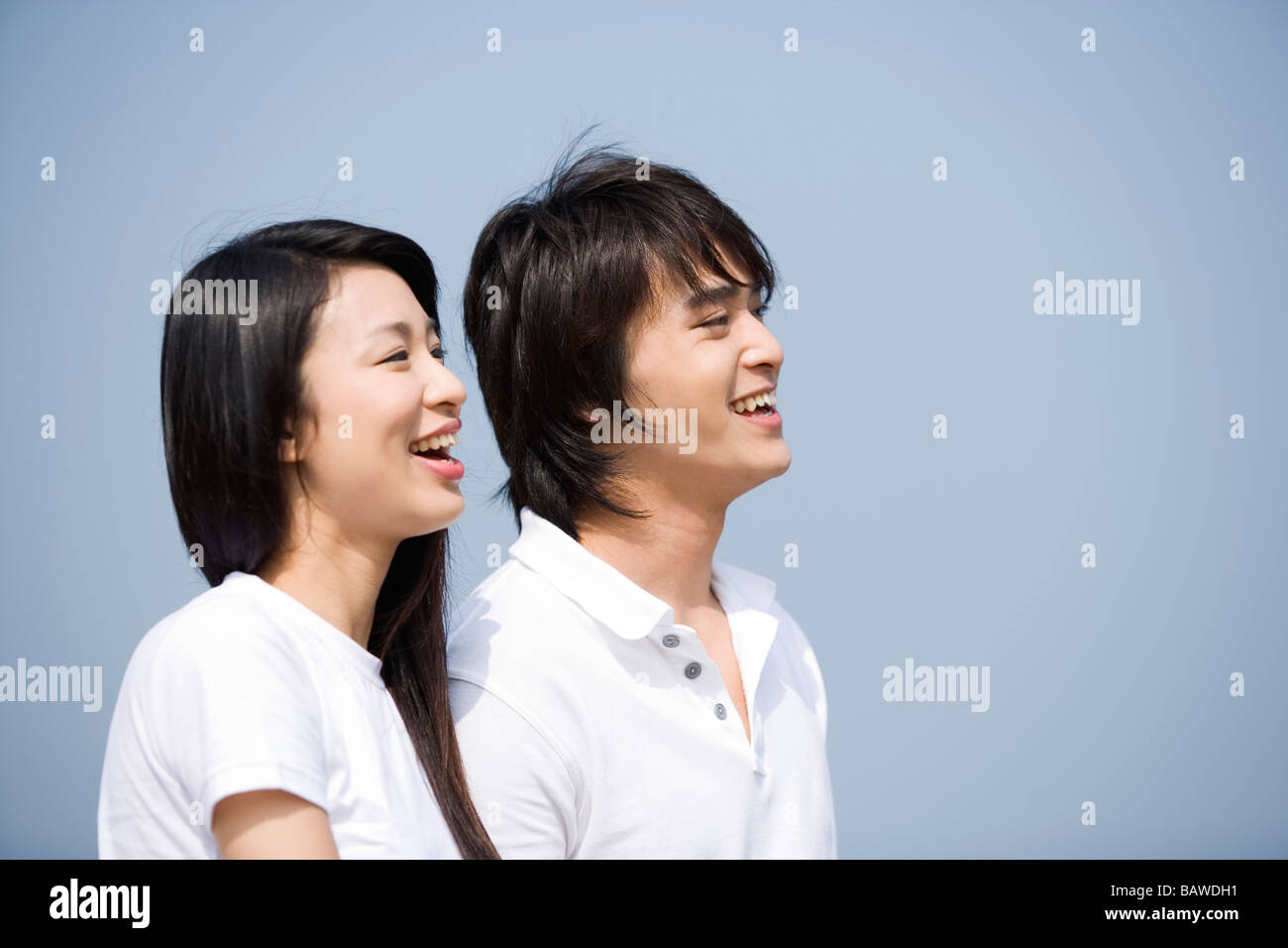 Young couple toothy smiling side view Stock Photo